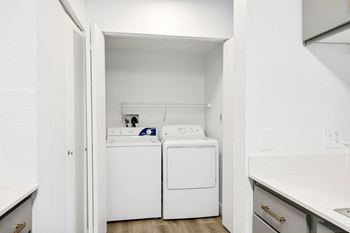 A small laundry room with a washer and dryer.